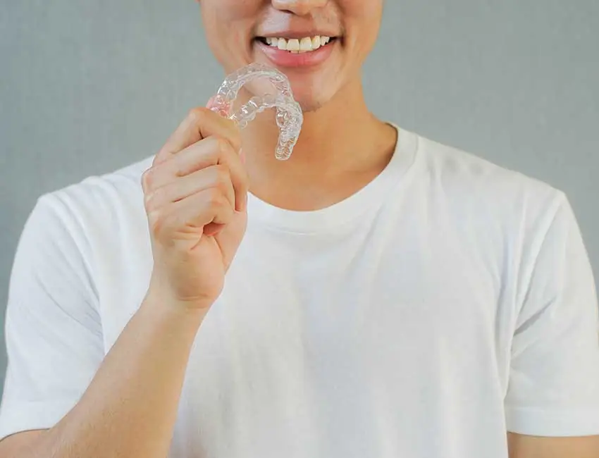 Patient holding mouthguard