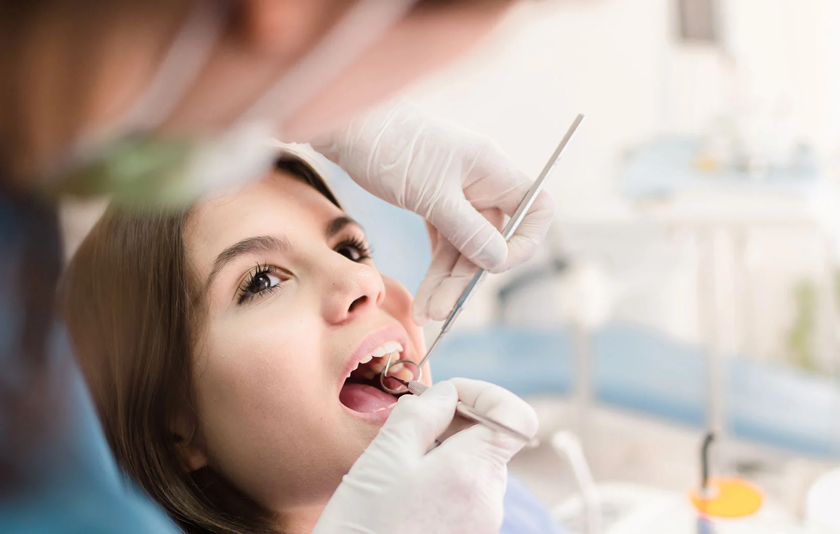 Dentist checking patients teeth